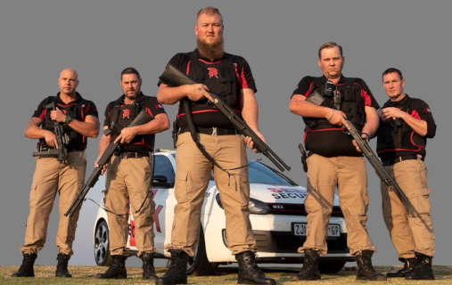 Seek Security armed protection team standing in front of a company vehicle